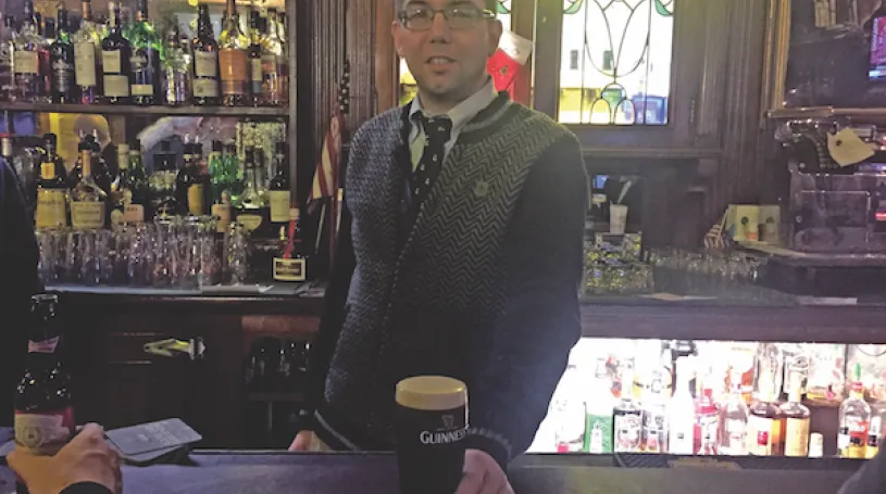 Fourth-generation Peter McManus Cafe owner Justin McManus serves up a well-poured Guinness. File photo by Dennis Lynch.